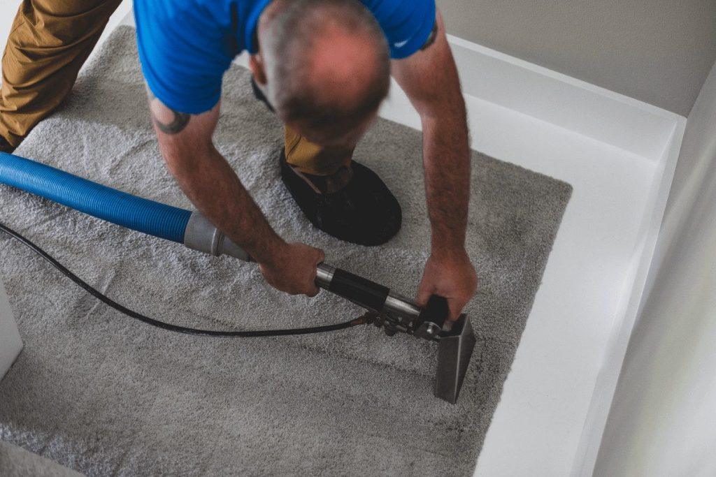 Hot water extraction being run across a carpet, close up